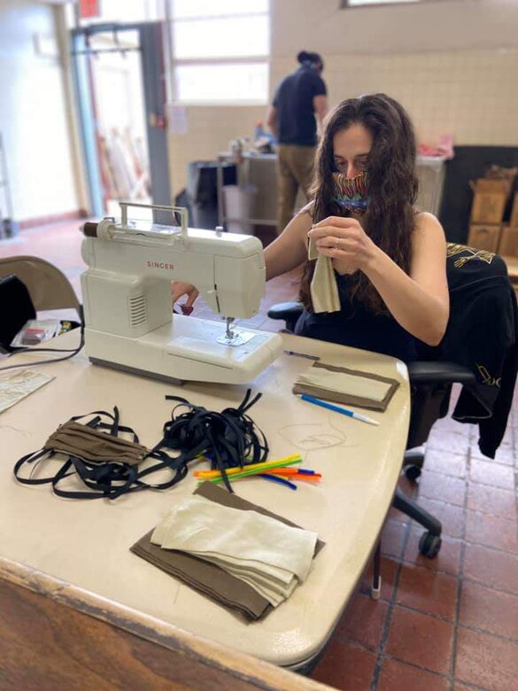 Lt. Col. Lauren Pecher, commander of Public Health Activity-San Diego, sews together a cloth face covering at the Camp Pendleton Branch Veterinary clinic, April 11, 2020. In response to the COVID-19 pandemic and Secretary of Defense guidance on the use of cloth face coverings, members of PHA-SD worked together to create cloth face coverings to help slow the spread of COVID-19. (Courtesy photo)