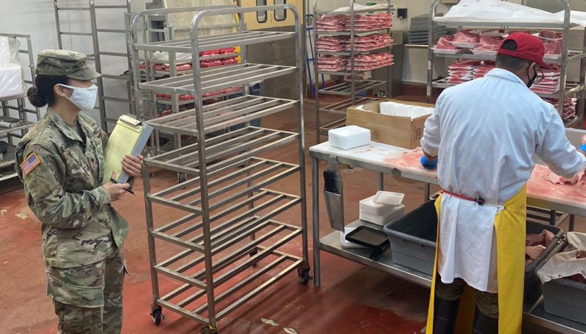 U.S Army Spc. Regina Shillingburg, Public Health Activity-Guam veterinary food inspection specialist, conducts a food inspection of the meat department at Orote commissary, Naval Base Guam, April 2020. To help keep the military community safe from COVID-19 and foodborne illness, PHA-Guam Soldiers assist Navy preventive medicine by inspecting approximately 40 facilities on base, including the commissary, Navy Exchange food court, shoppettes, galleys, and restaurants. (Courtesy Photo)