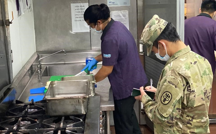 U.S. Army Spc. Raymond Cabusao, Public Health Activity-Guam veterinary food inspection specialist, conducts a food inspection at King's Restaurant, Tamuning, Guam, April 2020. King’s Restaurant is one of the facilities providing food to Sailors in quarantine as part of the mass feeding operations. (Courtesy Photo)