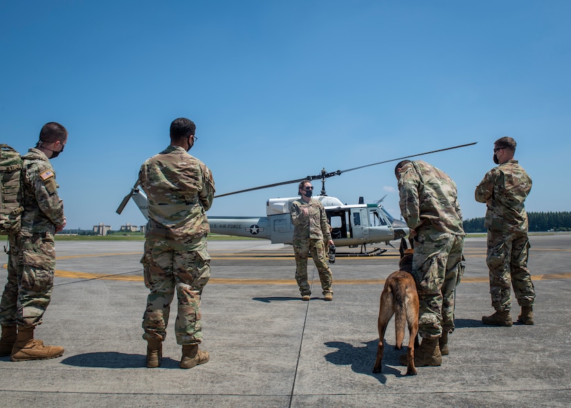 Maj. Kacey Ezell, 459th Airlift Squadron UH-1N chief pilot, briefs 374th Security Forces Squadron Airmen prior to a UH-1N familiarization and C-12 K-9 evacuation training scenario, August 20, 2020, at Yokota Air Base, Japan. During the training, 374th SFS military working dog handlers familiarized themselves with 459th AS mobility assets. (U.S. Air Force photo by Staff Sgt. Juan Torres)