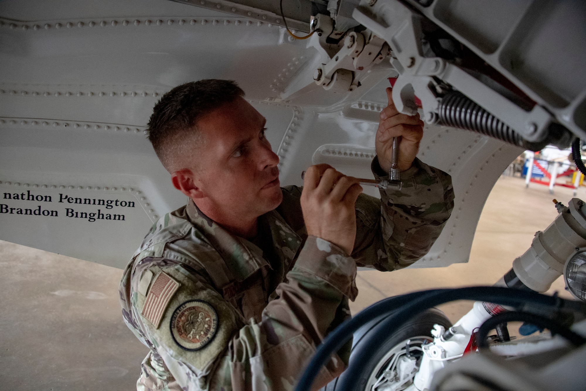 Airman 1st Class John Taylor Doolittle Jr. loosens battery bolts