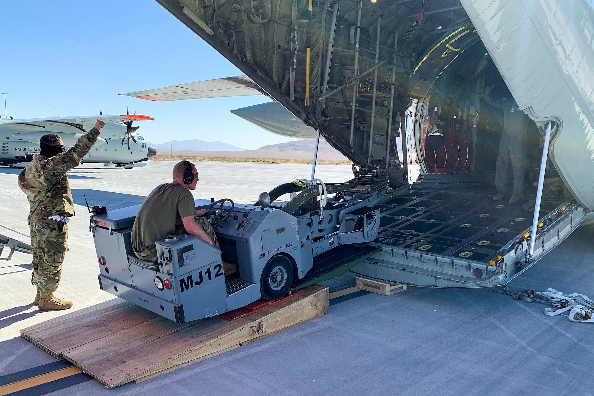 U.S. Air Force Airmen prepare to offload a weapon-loading jammer from a 109th Airlift Wing LC-130 Hercules aircraft Sept. 3, 2020, at Nellis Air Force Base, Nevada. Airmen are offloading cargo from the C-130 to prepare for an Integrated Combat Turn, which is the rapid re-arming and refueling of an aircraft. (Courtesy photo)