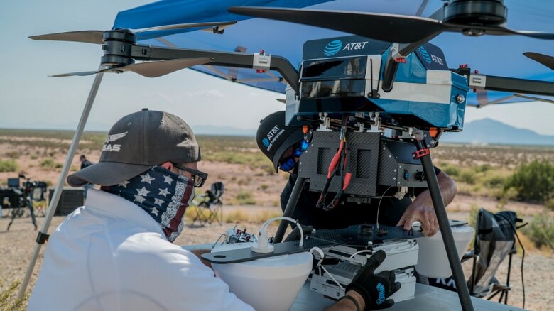 AT&T technicians and civilian contractors assemble a "Cell on Wings" drone in order to provide 5G connectivity to individuals participating in the Advanced Battle Management Systems Onramp 2 at White Sands Missile Range, N.M., Aug. 27, 2020. The ABMS is an interconnected battle network - the digital architecture or foundation - which collects, processes and shares data relevant to warfighters in order to make better decisions faster. (U.S. Air Force photo by Staff Sgt. Charlye Alonso)