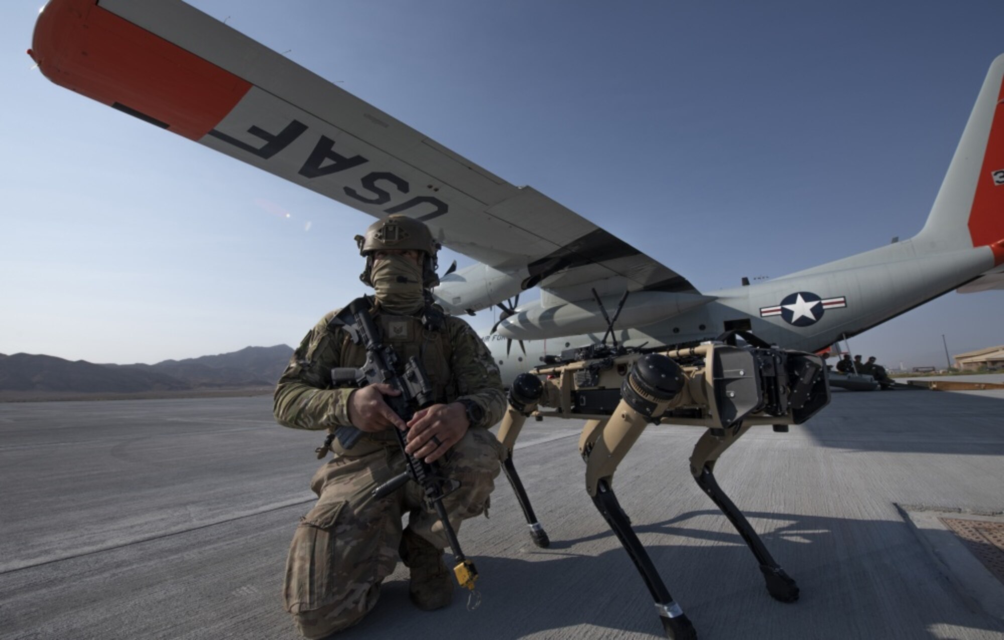 Tech. Sgt. John Rodiguez, 321st Contingency Response Squadron security team, provides security with a Ghost Robotics Vision 60 prototype at a simulated austere base during the Advanced Battle Management System exercise on Nellis Air Force Base, Nev., Sept. 1, 2020. The ABMS is an interconnected battle network — the digital architecture or foundation — which collects, processes and shares data relevant to warfighters in order to make better decisions faster. (U.S. Air Force photo by Tech. Sgt. Cory D. Payne)