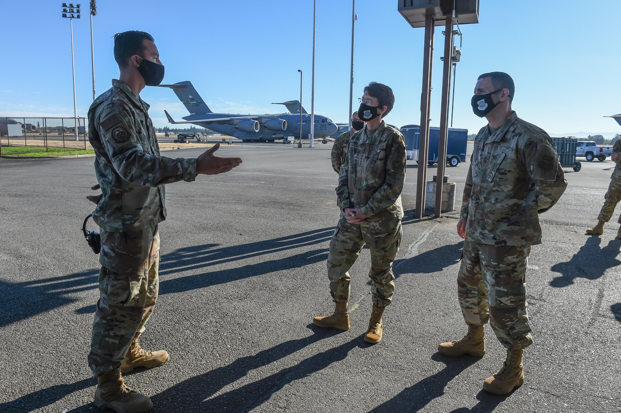 Tech. Sgt. Jereme Henson, 62nd Aerial Port Squadron special handling shift supervisor, briefs Gen. Jacqueline Van Ovost, Air Mobility Command commander, and Chief Master Sgt. Brian Kruzelnick, AMC command chief, about 62nd APS’s mission at Joint Base Lewis-McChord, Wash., Sept. 3, 2020. Van Ovost is currently touring AMC bases as part of her listening tour to learn from AMC Airmen. (U.S. Air Force photo by Airman 1st Class Mikayla Heineck)