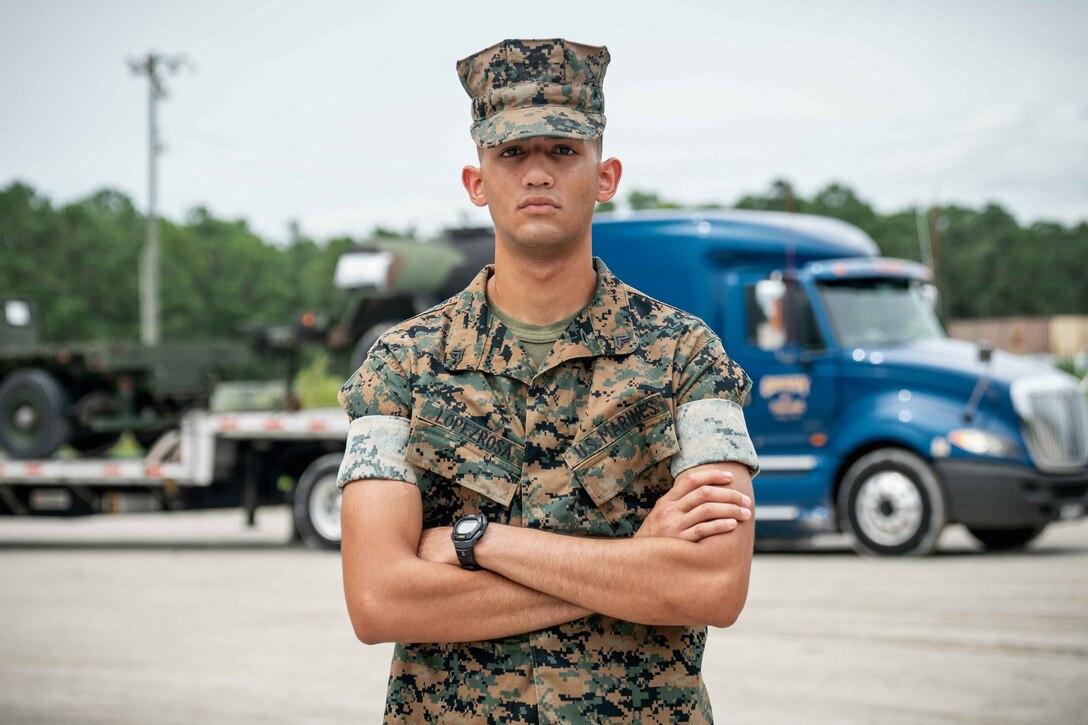 Cpl. Christian M. Lopez Rosa, embarkation chief, with Combat Logistics Regiment 27, 2nd Marine Logistics Group, poses for a photo on Camp Lejeune, N.C., September 7, 2020. “Don’t live off the legacy that comes with being a Marine, LIVE UP to the legacy – earn the title everyday.” said LopezRosa, a Puerto Rico, native. According to hid leadership Cpl Lopez Rosa is a natural leader who never hesitates to take charge of any situation regardless of the circumstances and continually excels in leading his subordinates and peers alike. Due to this take-charge mentality, he has been assigned as the 2d MLG embarkation chief, a billet which has previously been filled by a staff sergeant. Within this billet, Cpl Lopez Rosa works with all 2d MLG mobility officers and senior staff noncommissioned officers by validating and correcting unit deployment data for every subordinate unit within 2d MLG. Additionally, he was assigned as the senior 2d MLG representative for the Air Liaison Element in support of MWX 1-20 at March Air Base, California. He was responsible for the reception of personnel and equipment helping move thousands of Marines to Marine Air Ground Combat Center, Twentynine Palms. Since arriving to this unit, Cpl Lopez Rosa has made and incredible impact on subordinate and senior Marines alike. Despite the constant pressure from senior Marines within the mobility community to become a 0430 mobility officer, he plans to go first sergeant/sergeant major route. (U.S. Marine Corps photo by Cpl. Rachel K. Young-Porter)