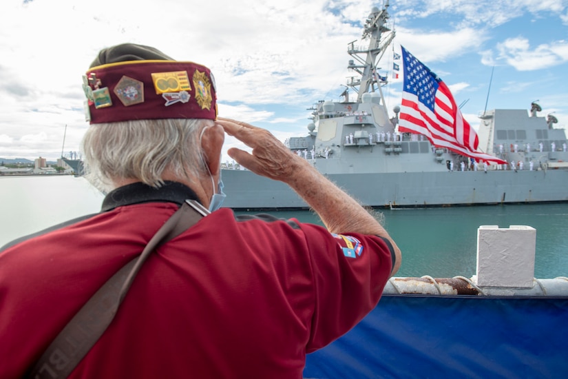 A veteran salutes a military ship.