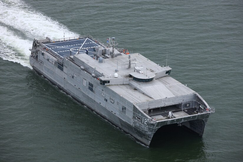 A military ship moves through the water.