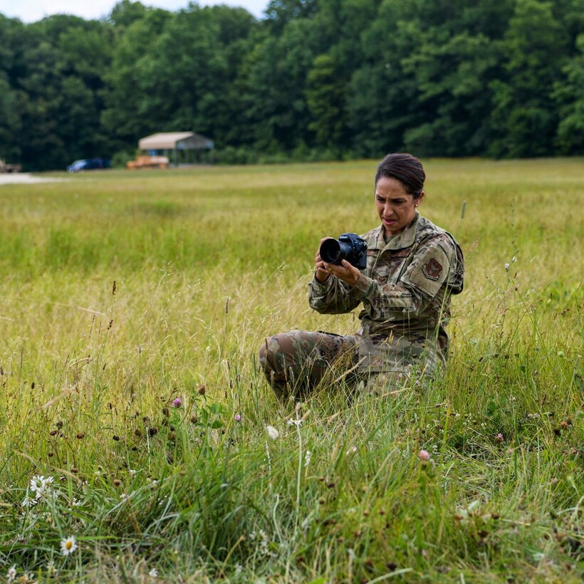 Senior Airman Christina Russo, a public affairs specialist with the 910th Airlift Wing, takes a video of a cargo drop training mission, July 14, 2020, at Camp Garfield in Ravenna, Ohio. As a public affairs specialist, Russo is trained to capture both still photography and video to tell the Air Force story.