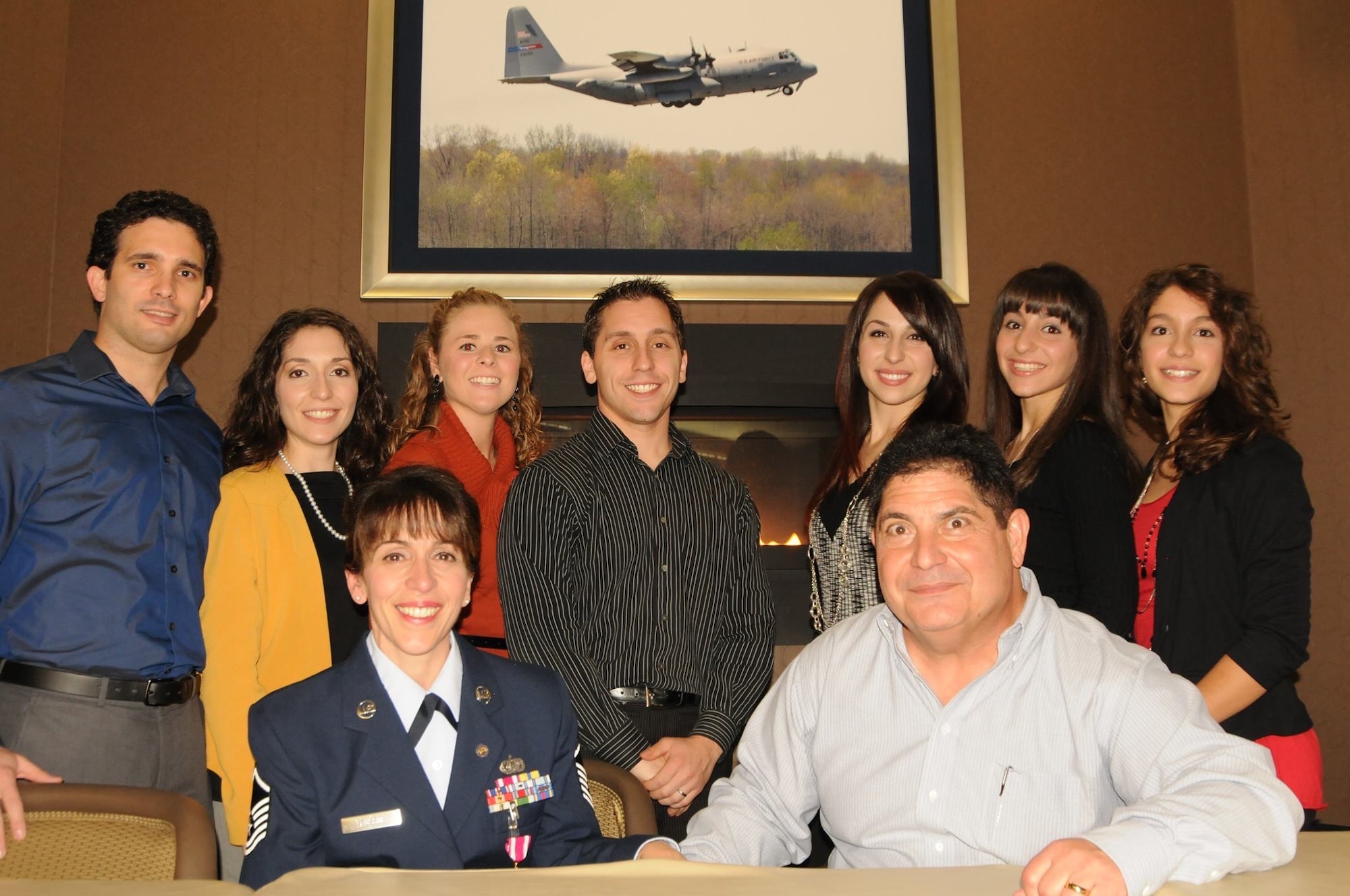 Master Sgt. Anna Marie Russo, an administrative assistant to the 910th Airlift Wing commander, poses for a photo with her family on Nov. 17, 2013, at Youngstown Air Reserve Station. Russo retired after 33 years of service in the Air Force Reserve.