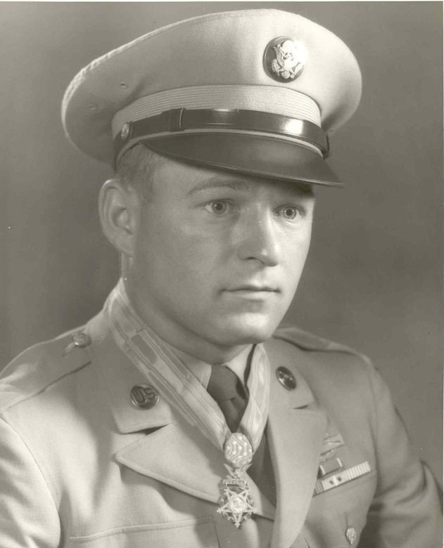 A soldier in cap and dress uniform wears the Medal of Honor.