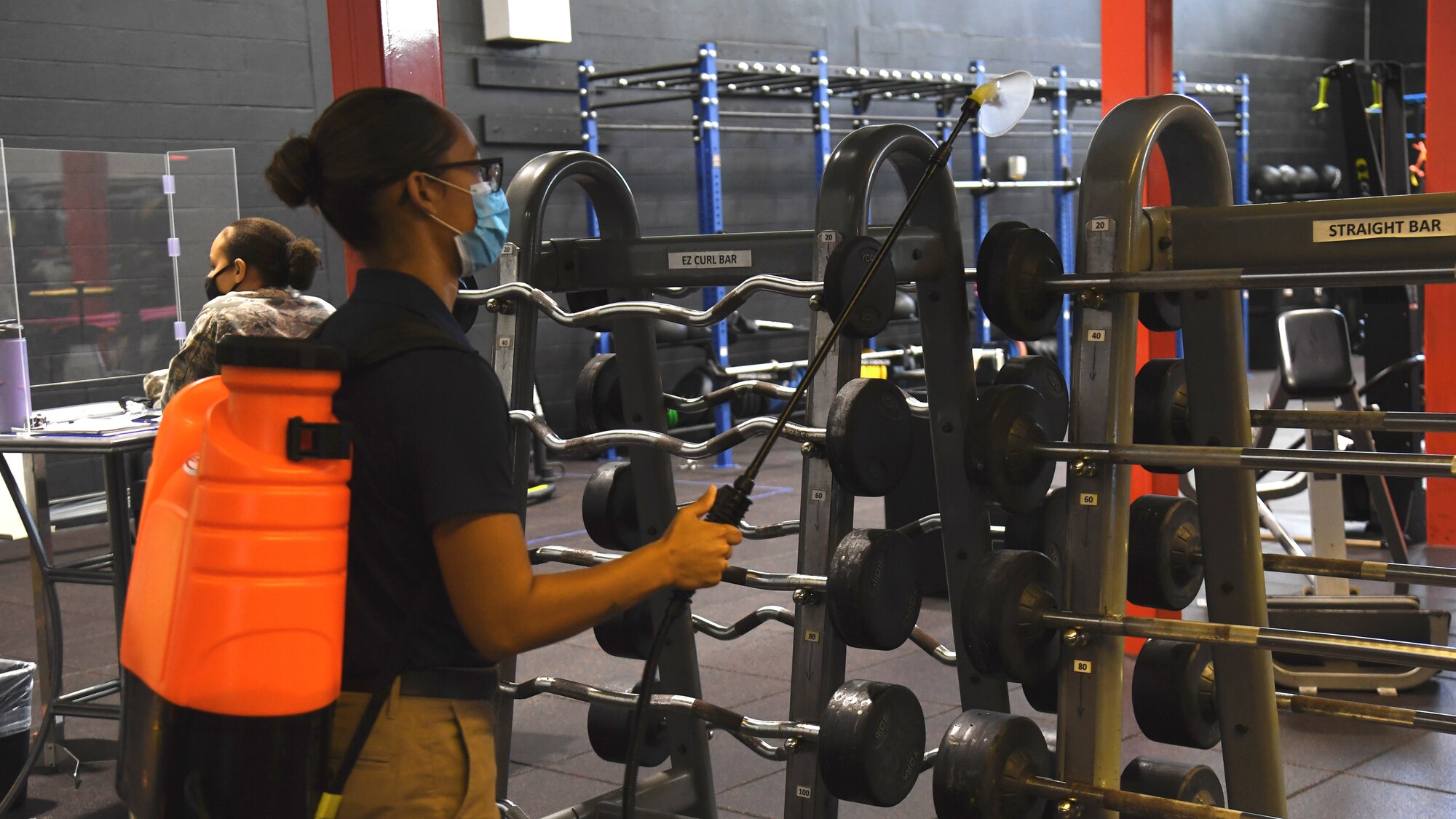 U.S. Air Force Staff Sgt. Antigone Bagtas, a 6th Force Support Squadron (FSS) fitness program manager, sprays disinfectant onto fitness center equipment, Sept. 2, 2020, at MacDill Air Force Base, Fla.