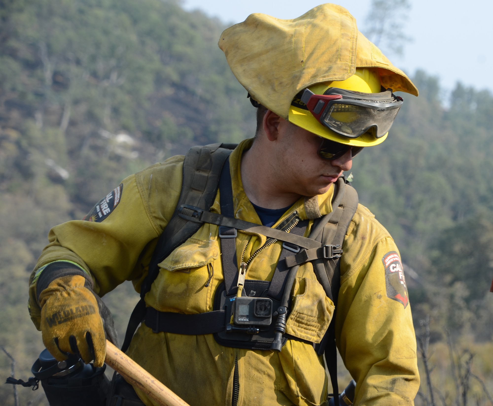 U.S. Army Spc. Daniel Rincon, a hand crew member with Fresno-based Joint Task Force Rattlesnake Alpha team, on the steep slope of Rumsey Canyon where he and other members of the California State and National Guard help try to contain the LNU Lightning Complex fire near Rumsey, Aug 30, 2020.