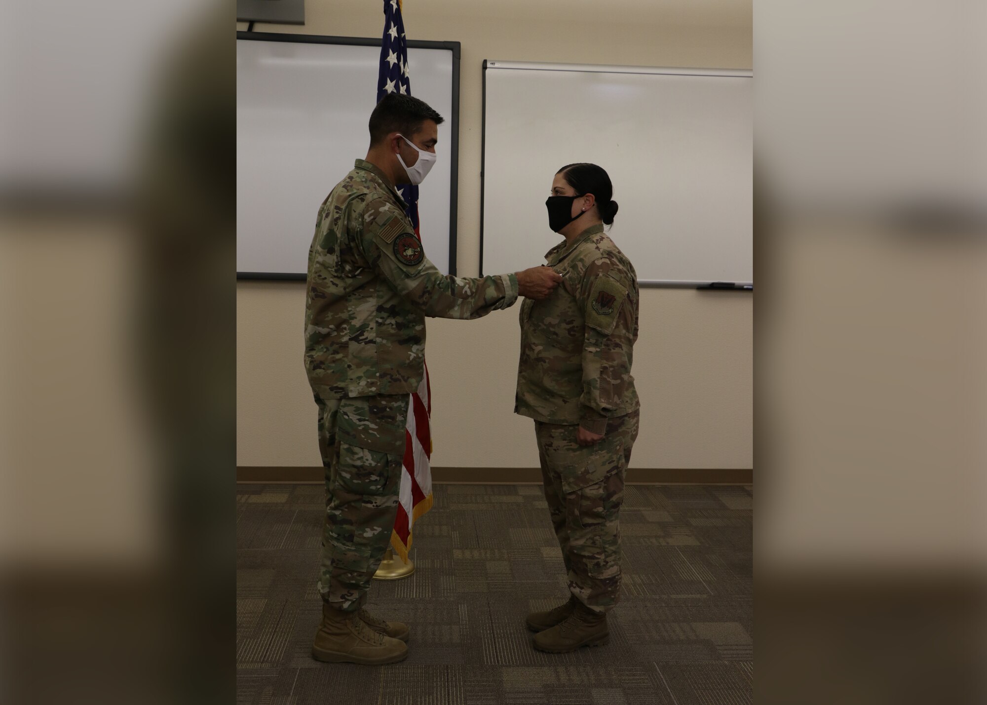 Col. Richard A. Goodman, 366th Fighter Wing commander, presents the Bronze Medal award to Capt. Kristen Miranda, 366th Force Support Squadron operations officer, August 20, 2020, at Mountain Home Air Force Base. Miranda served as the director of operations for the 405th Expeditionary Support Squadron at Bagram Airfield, Afghanistan, from April 2019 to April 2020. (U.S. Air Force Photo courtesy of Shelly Turner)