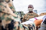 Gunnery Sgt. Luckner Desma answers questions about his contact tracing log during a COVID-19 Rapid Response Team drill aboard USS Germantown (LSD 42).