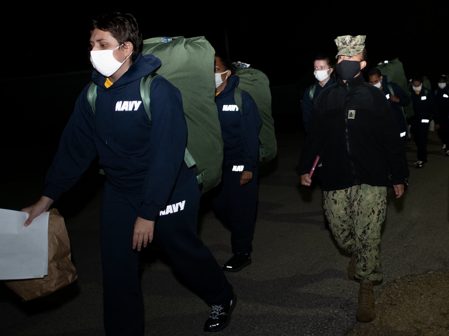 Senior Chief Hospital Corpsman Genena Palacios assigned to Commander, Navy Recruiting Command in Millington, Tenn., walks new recruits to their barracks on board Fort McCoy, a U.S. Army training center in western Wisconsin.