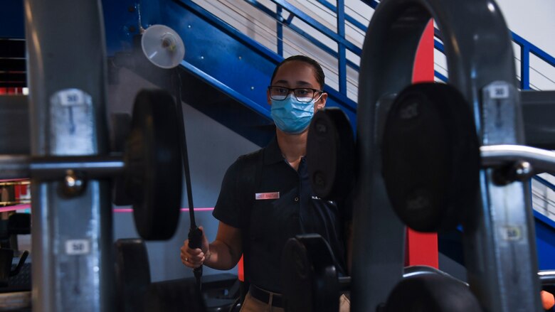U.S. Air Force Staff Sgt. Antigone Bagtas, a 6th Force Support Squadron (FSS) fitness program manager, sprays disinfectant onto fitness center equipment, Sept. 2, 2020, at MacDill Air Force Base, Fla.