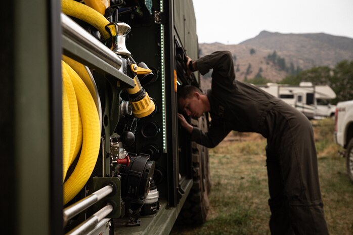 A U.S. Marine conducts an equipment check at an interagency improvised helicopter airfield near Coleville, Calif., Sept. 6.