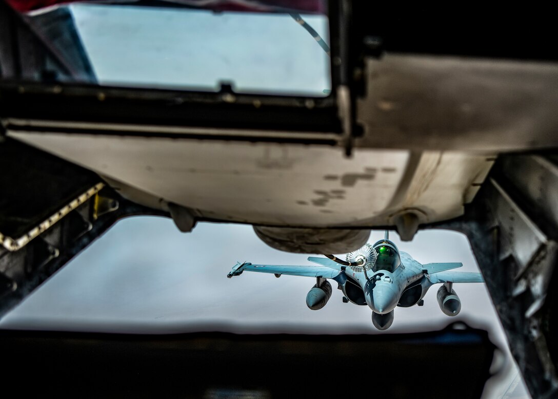 A French Rafale connects to a fuel line of a KC-10 Extender from the 908th Expeditionary Air Refueling Squadron during a large force employment, Aug. 25, 2020, at Al Dhafra Air Base, United Arab Emirates.