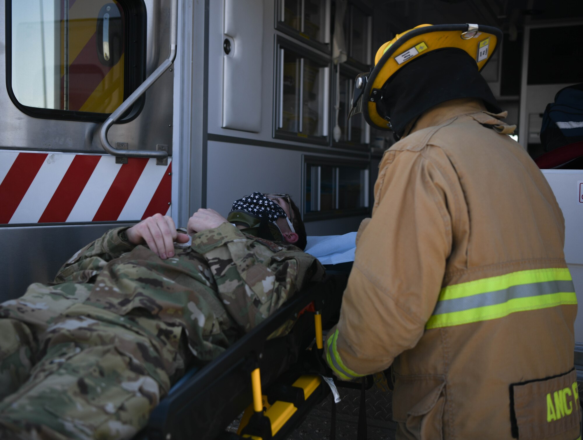 A firefighter from the 380th Expeditionary Civil Engineer Squadron wheels a victim into an ambulance during the Major Accident Response Exercise (MARE) September 3, 2020, at Al Dhafra Air Base, United Arab Emirates.