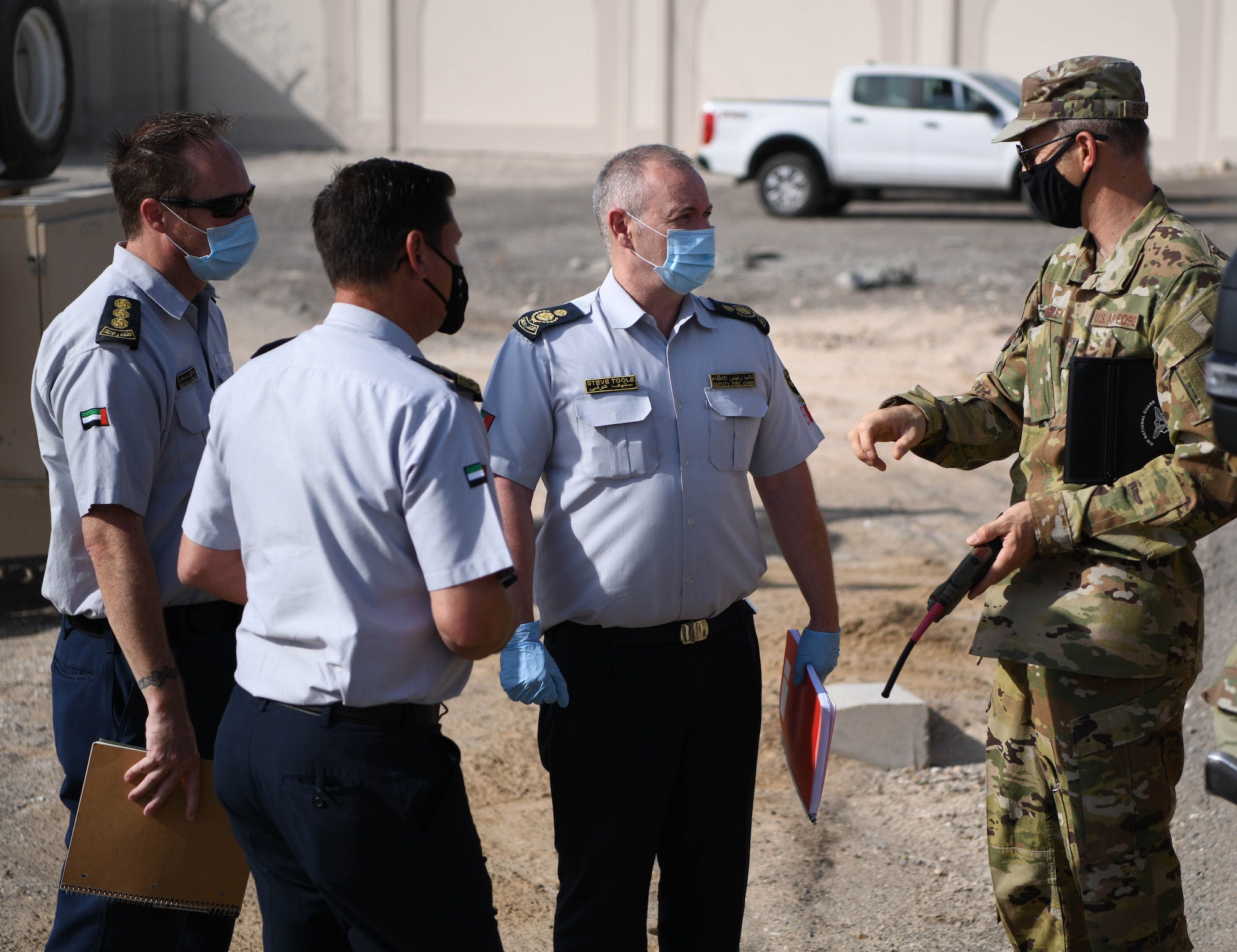 Chief Master Sgt. Christopher Brearley (right), 380th Expeditionary Civil Engineer Squadron fire chief, explains happenings in an accident scene to the United Arab Emirates first responders during the Major Accident Response Exercise (MARE) Thursday, Sept. 3, 2020 at Al Dhafra Air Base, United Arab Emirates.