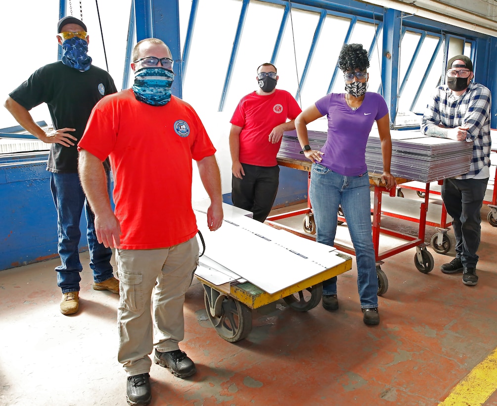 Norfolk Naval Shipyard’s Nuclear Sheetmetal Shop (Shop 17) has installed over 6,000 feet of personnel guards to aid in the fight against COVID-19. The team spearheading this effort is composed of Sheetmetal Mechanics Matt Legg, Thomas Deller, Brian Nipper, Steven Myers, and Monica Cooper.
