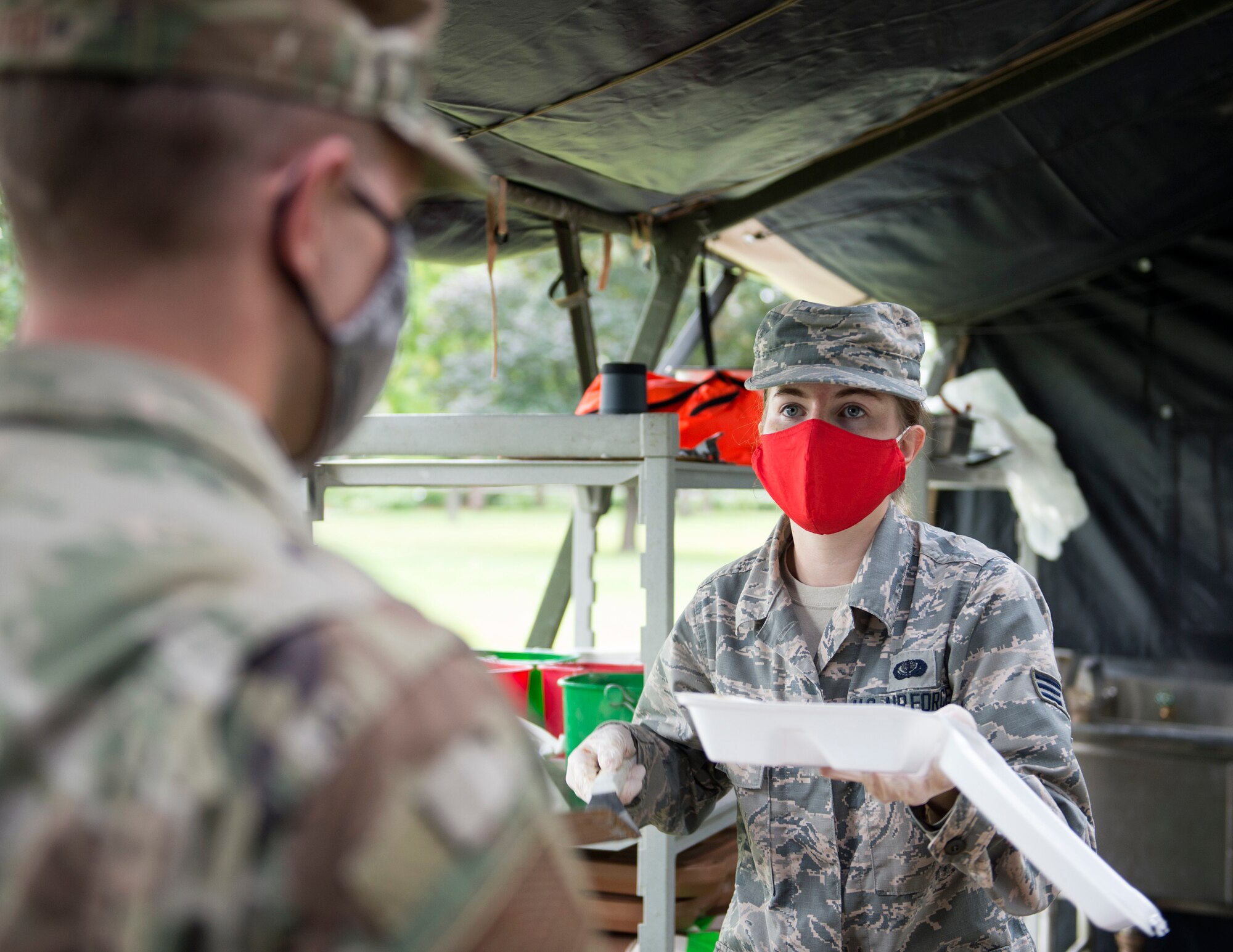 U.S. Air Force Senior Airman Andrea Cooper, 133rd Sustainment Services Flight, serves food in St. Paul, Minn., Aug. 20, 2020.
