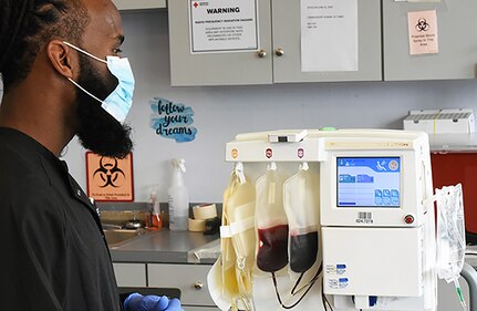Steve Holton, a collection specialist and site supervisor for the East End Louisville American Red Cross Blood Donation Center, monitors the apheresis process, so named for separating whole blood into parts to use as needed. Yellow plasma is collected into the left bag, to be used for the treatment of COVID-19.