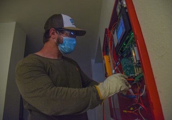 Jeffrey Rhodes, 4th Civil Engineer Squadron electronics technician, performs a general maintenance check on a dorm building alarm system at Seymour Johnson Air Force Base, North Carolina, August 31, 2020.