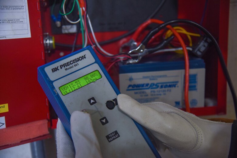 Marlon McKoy, 4th Civil Engineer Squadron alarm section work lead, checks the battery of an alarm system at Seymour Johnson Air Force Base, North Carolina, August 31, 2020.