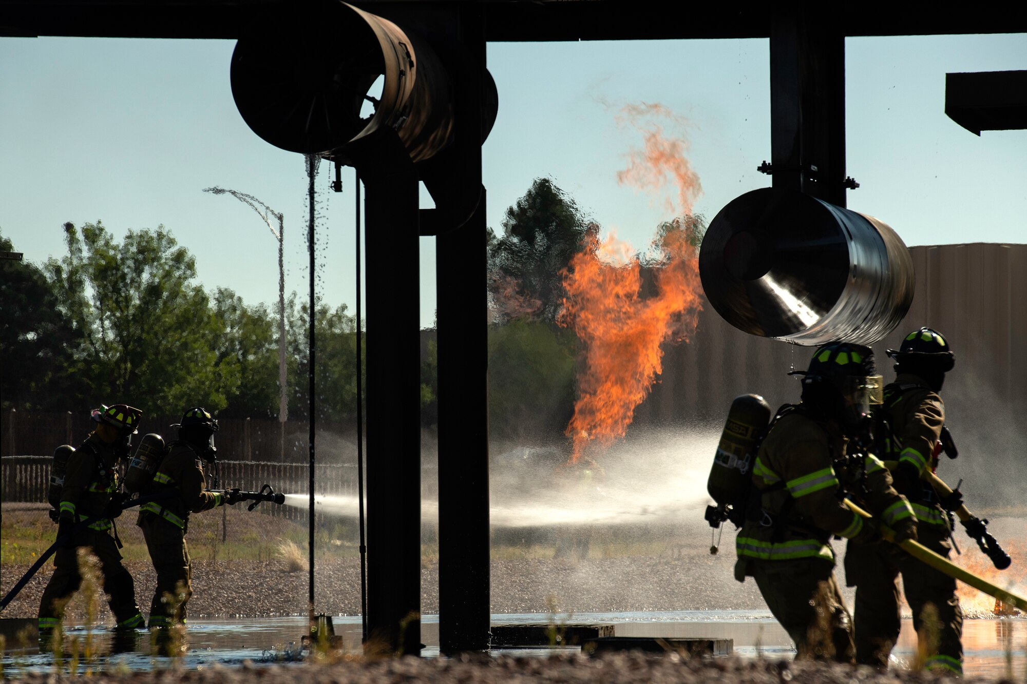 Picture of firefighters using hose to put out fire