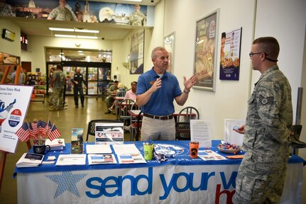 James Brady, 14th Force Support Squadron community readiness specialist and installation voting assistance officer, talks with Air Force Staff Sgt. Cory Henning, 14th Civil Engineer Squadron, during Armed Forces Voters Week in the base exchange on Columbus Air Force Base, Miss., June 27, 2018. Though federal election years have a large effect on the voting community and activity, elections are happening across the country every year.