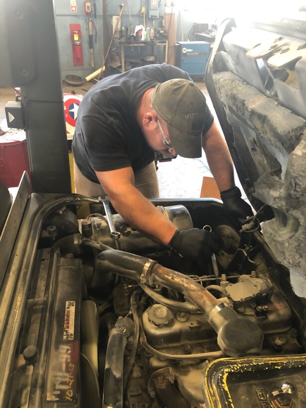 Tim Purinton, an automotive mechanic at Arnold Air Force Base, works to repair a vehicle at the Motor Pool facility. Purinton is an employee with Akima Intra-Data, an Alaskan Native small business contracted to conduct Facility Support Services for Arnold. (U.S. Air Force photo)