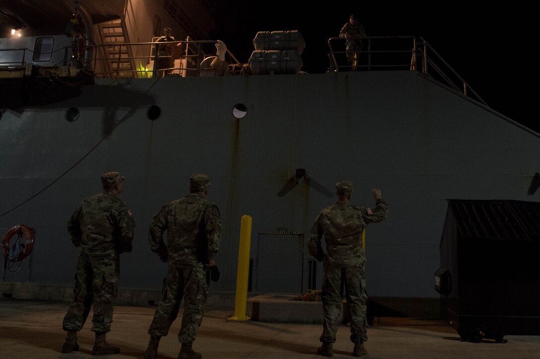 Soldiers welcome crew members at the dock.