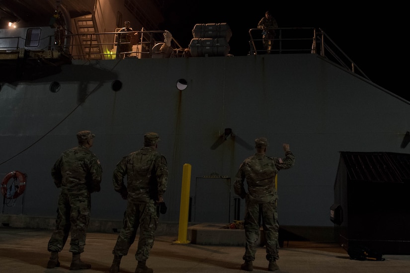 Soldiers welcome crew members at the dock.