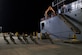 Soldiers pull the gangway into position for a ship.