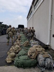 Soldiers load their bags onto vehicles prior to starting a 160-mile convoy from Camp Humphreys to Camp Carroll during a 563rd Medical Logistics Company field training exercise, held Aug. 15-22 in South Korea.