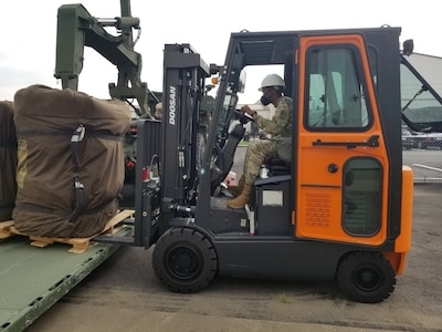 Spc. Katrale D. Brown operates a forklift to load deployable shelter equipment as part of the 563rd Medical Logistics Company's field training exercise, held Aug. 15-22 in South Korea.
