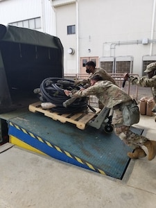 Soldiers with the 563rd Medical Logistics Company's forward logistics element load power distribution cables as part of a field training exercise, held Aug. 15-22 in South Korea.