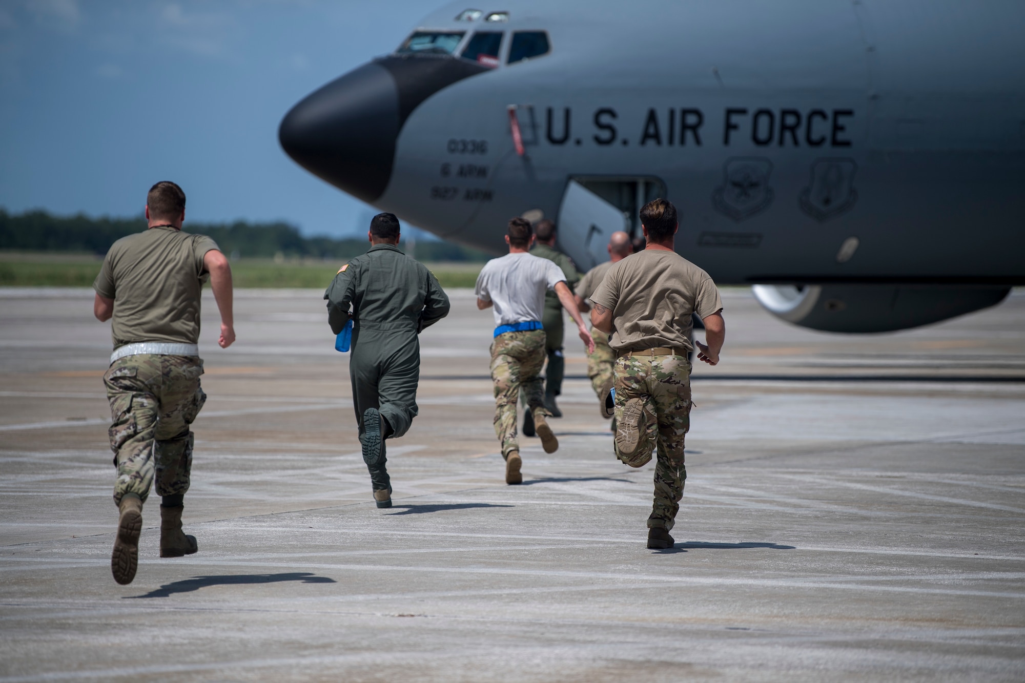 Members of Team MacDill sprint toward a KC-135 Stratotanker aircraft during a joint readiness exercise at MacDill Air Force Base, Fla., Aug. 29, 2020.