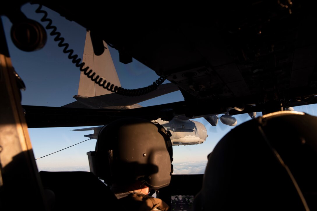 Aircrew members of a CV-22B Osprey look at a MC-130J Commando II, all based out of RAF Mild-enhall, U.K., while being aerially refueled during a training exercise near Bodø, Norway, August 27, 2020. Integration with the Norwegian Air Force allowed the 352d Special Operations Wing to enhance and strengthen bonds with our partner nation and further secure the strategic high-north region. The exercise provided training for 352d Special Operations Wing members on capabilities such as personnel recovery, forward area refueling point, aerial refueling, maritime craft delivery system, and fast rope training. (U.S. Air Force photo by Staff Sgt. Michael Washburn)