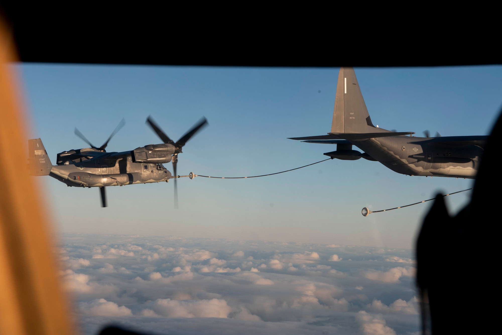 A MC-130J Commando II refuels a CV-22B Osprey, all based out of RAF Mildenhall, U.K., during a training exercise near Bodø, Norway, August 27, 2020. Integration with the Norwegian Air Force al-lowed the 352d Special Operations Wing to enhance and strengthen bonds with our partner nation and further secure the strategic high-north region. The exercise provided training for 352d Special Opera-tions Wing members on capabilities such as personnel recovery, forward area refueling point, aerial refu-eling, maritime craft delivery system, and fast rope training. (U.S. Air Force photo by Staff Sgt. Mi-chael Washburn)