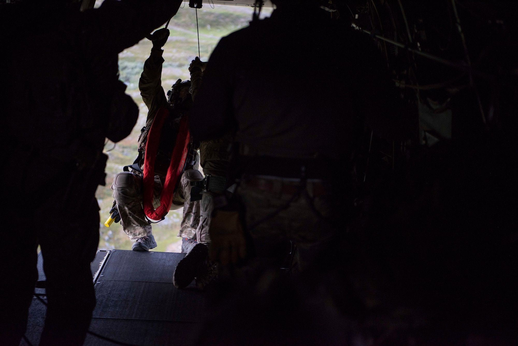 A 321st Special Tactics Squadron Airman descends from a CV-22B Osprey, based out of RAF Milden-hall, U.K., to rescue a downed aircraft crew member during a training mission near Bodø, Norway, Au-gust 27, 2020. Integration with the Norwegian Air Force allowed the 352d Special Operations Wing to enhance and strengthen bonds with our partner nation and further secure the strategic high-north re-gion. The exercise provided training for 352d Special Operations Wing members on capabilities such as personnel recovery, forward area refueling point, aerial refueling, maritime craft delivery system, and fast rope training. (U.S. Air Force photo by Staff Sgt. Michael Washburn)