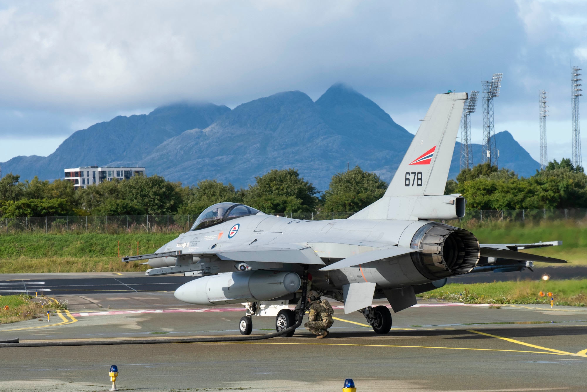 A forward area refueling specialist with the 100th Logistics Readiness Squadron refuels a Royal Nor-wegian Air Force F-16 Fighting Falcon during a training exercise at Rygge Air Station, Norway, August 26, 2020. Integration with the Norwegian Air Force allowed the 352d Special Operations Wing to en-hance and strengthen bonds with our partner nation and further secure the strategic high-north region. The exercise provided training for 352d Special Operations Wing members on capabilities such as per-sonnel recovery, forward area refueling point, aerial refueling, maritime craft delivery system, and fast rope training. (U.S. Air Force photo by Staff Sgt. Michael Washburn)