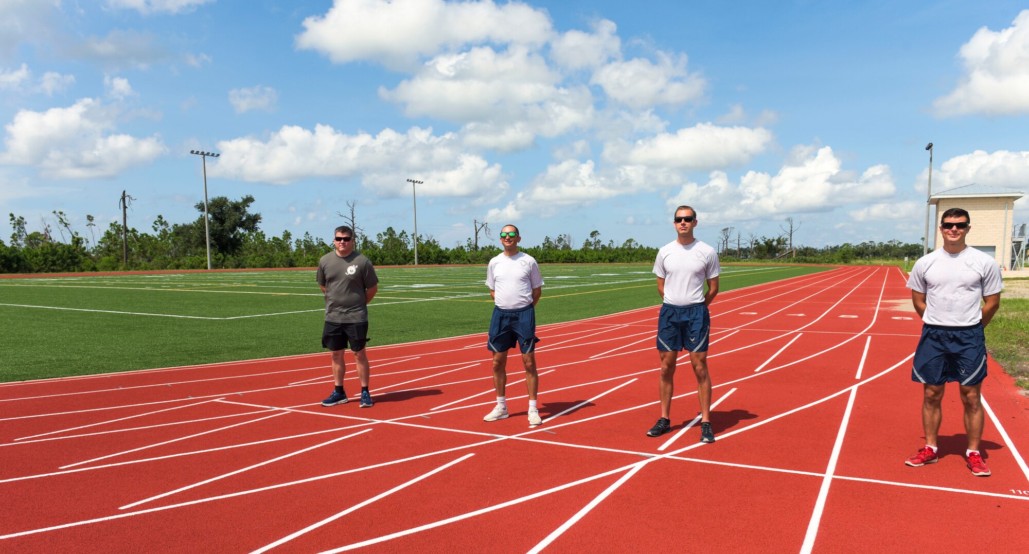 U.S. Air Force Staff Sgt. Aaron Bell with the 325th Force Support Squadron, left, Capt. Robert Friedman with the Air Force Legal Operations Agency, Tech. Sgt. Joshua Skinner with the 601st Air Operations Center, and Capt. Kyle Imhoff with the Air Force Civil Engineer Center, right, pose for a photo on the fitness track at Tyndall Air Force Base, Florida, Sept. 8, 2020. Bell led the Focus 5/6 group that organized a running fitness event for Airmen during the month of August. The top three runners were recognized and included Skinner with 348 miles, Friedman with 356 miles, and Imhoff with 366 miles. (U.S. Air Force photo by Staff Sgt. Magen M. Reeves)