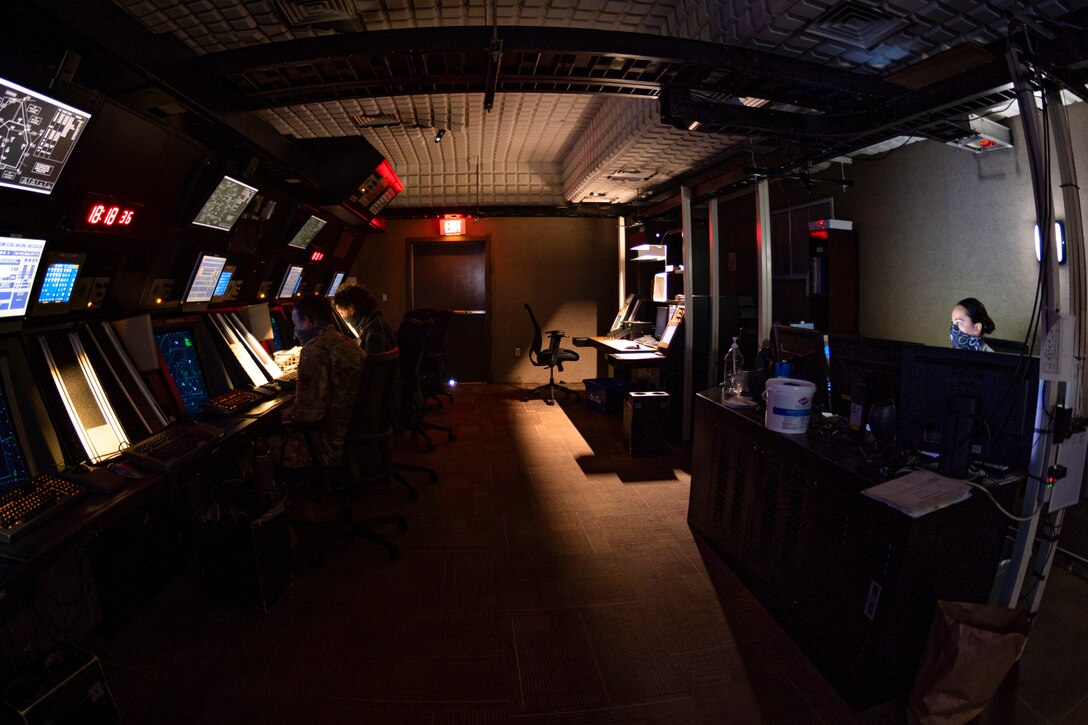 A photo of Airmen looking over flight information