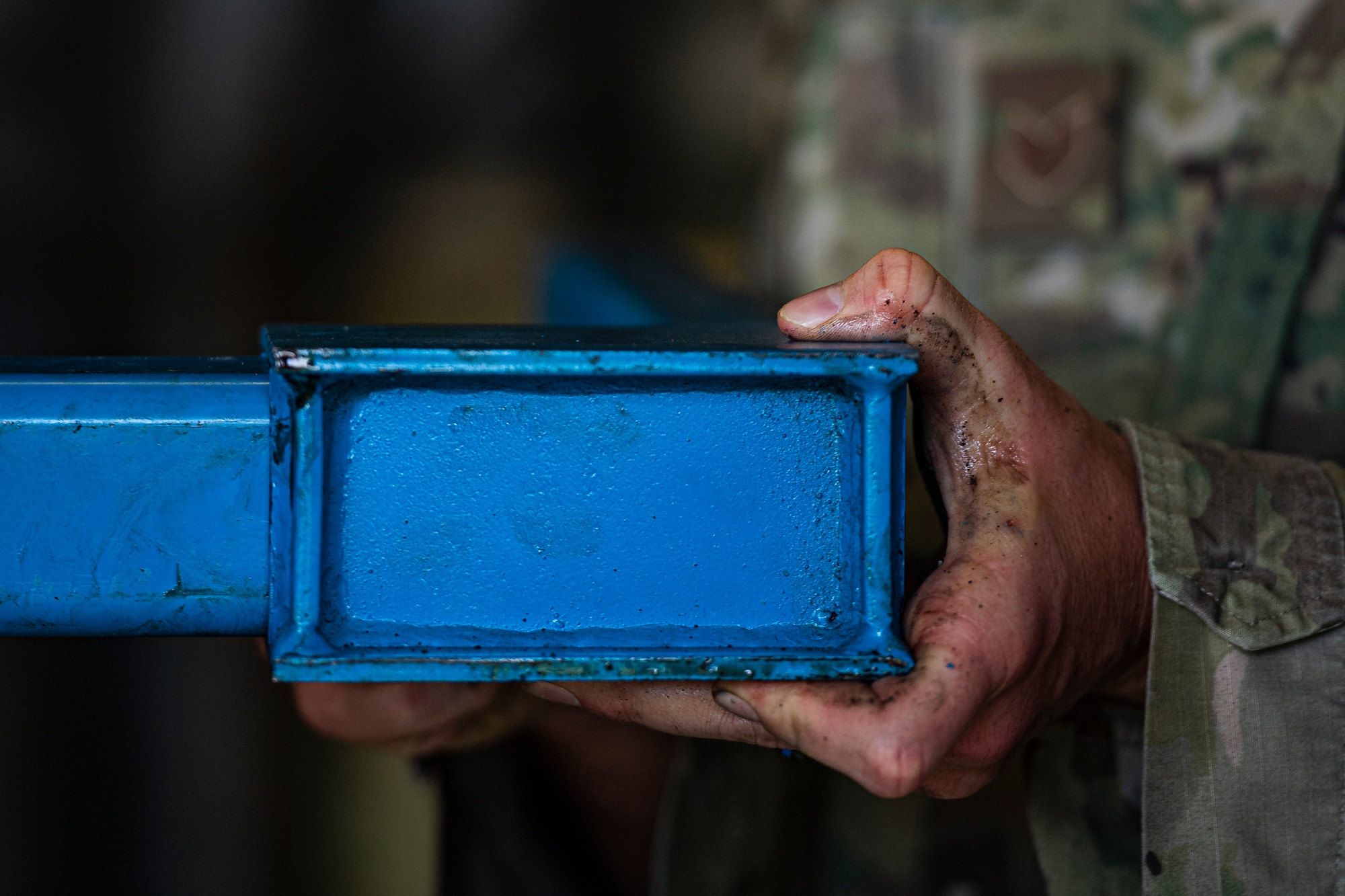 A photo of an Airman assembling a motor lift