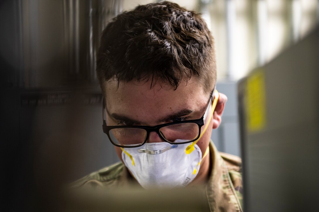 A photo of an Airman looking over technical orders