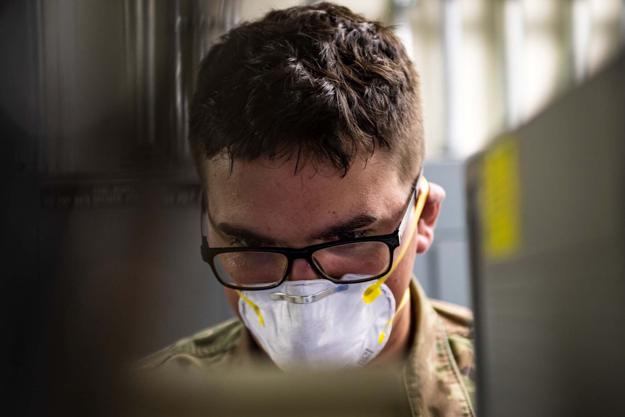 A photo of an Airman looking over technical orders