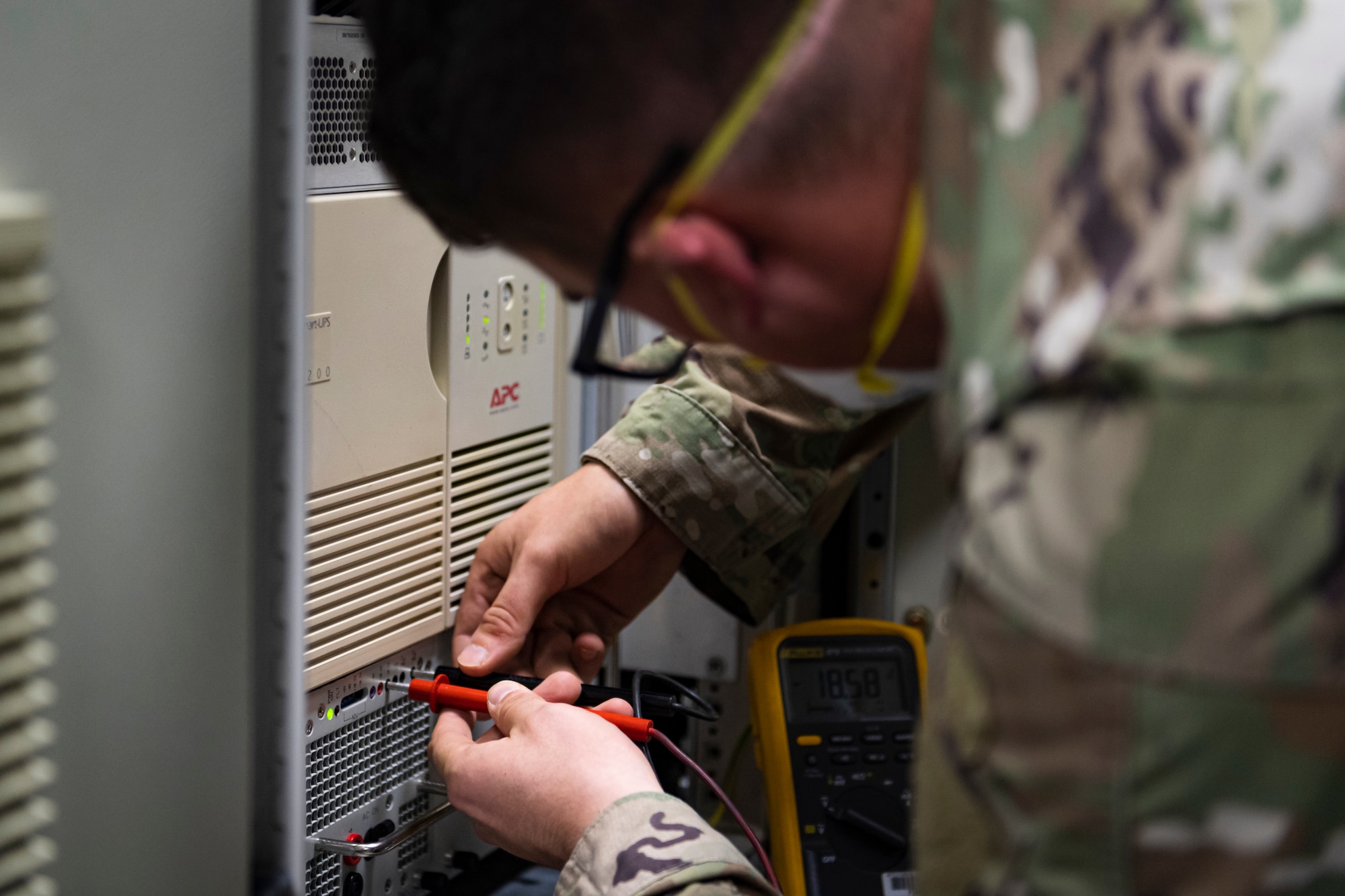 A photo of an Airman using a voltmeter